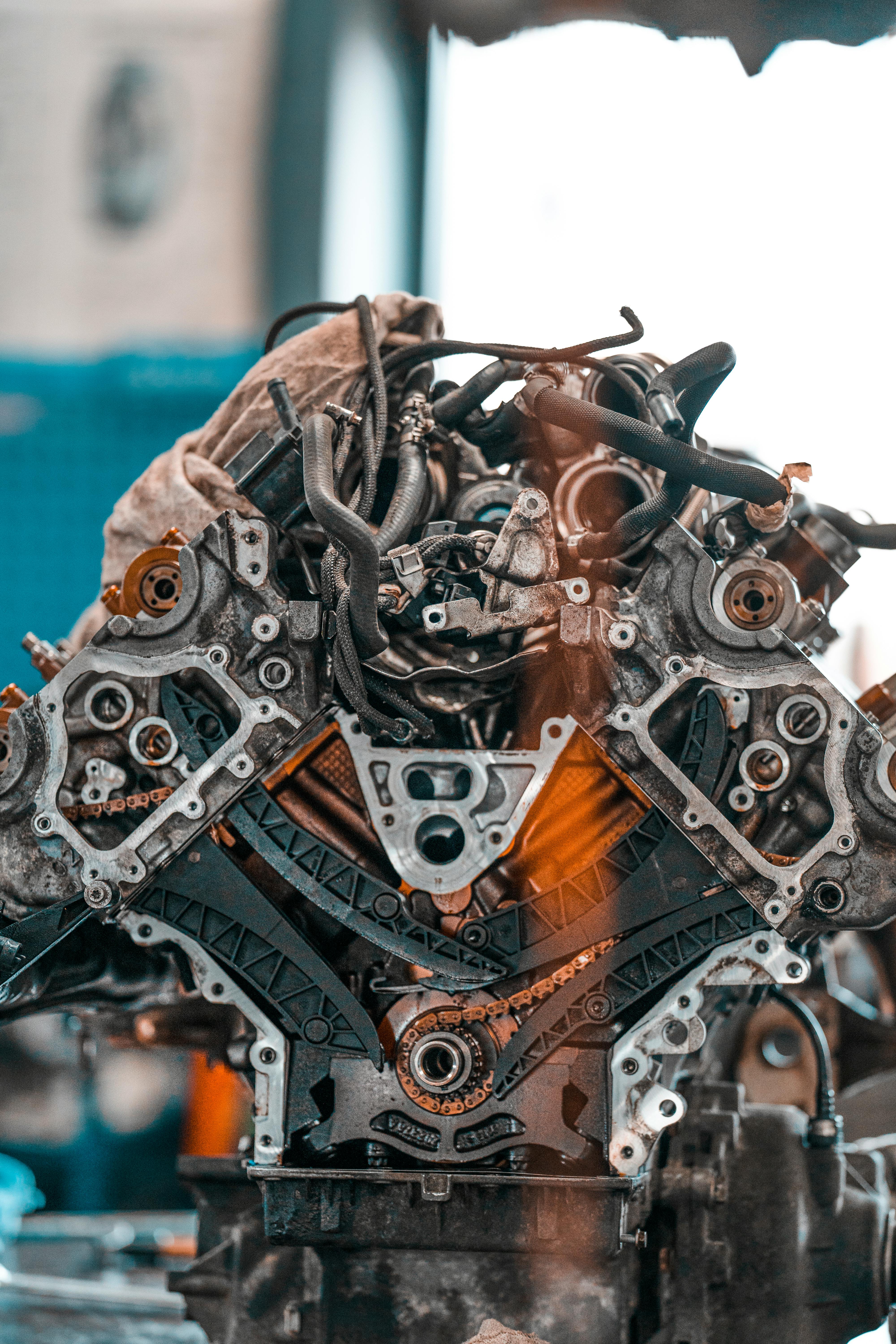 Engine being lifted with red straps for engine rebuilding London in a BNS MOTORS