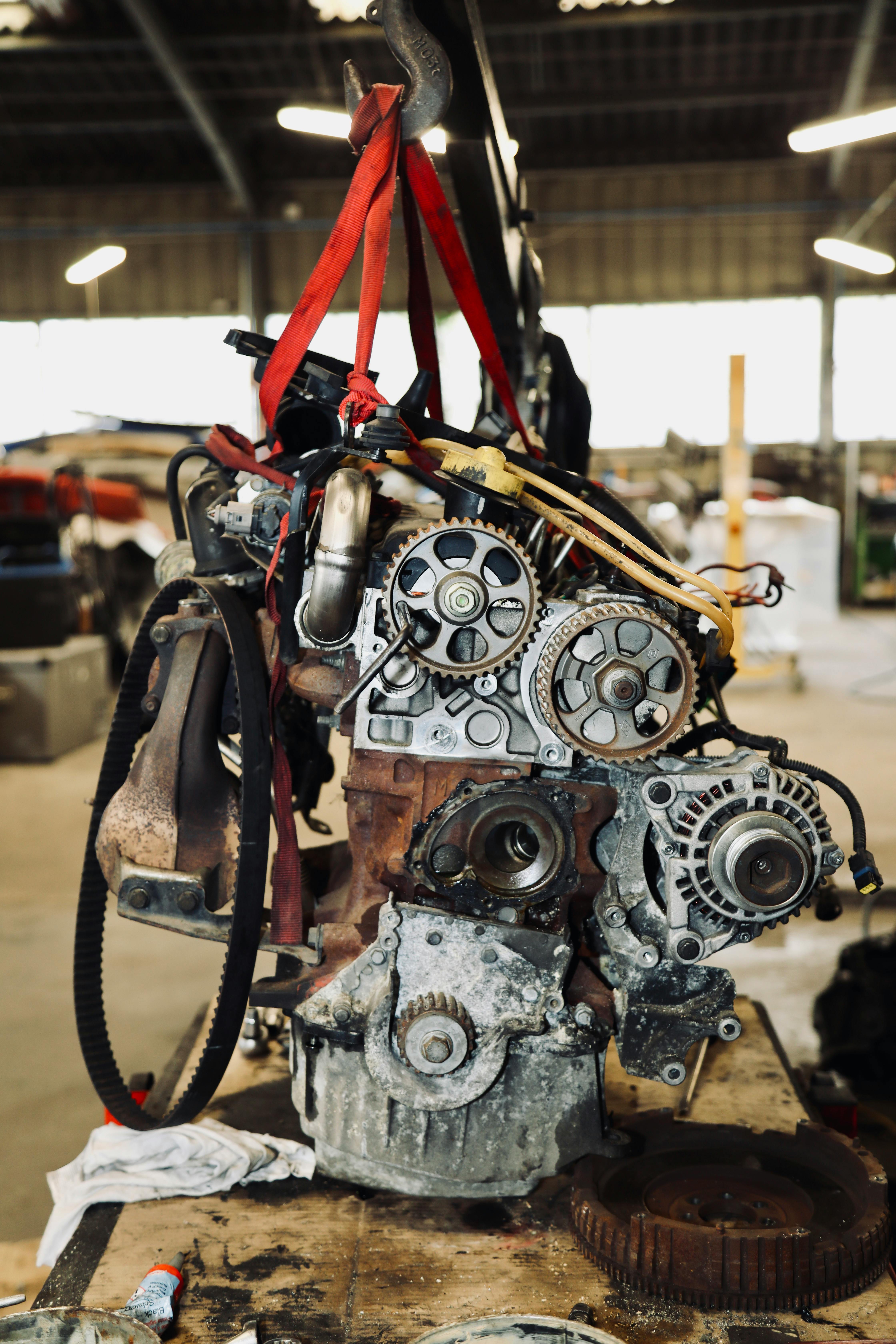 Close-up of car engine components on workbench during engine rebuilding London at BNS MOTORS