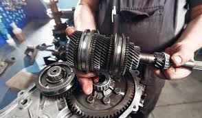 Car transmission assembly being serviced by vehicle technician for transmission repair at BNS MOTORS