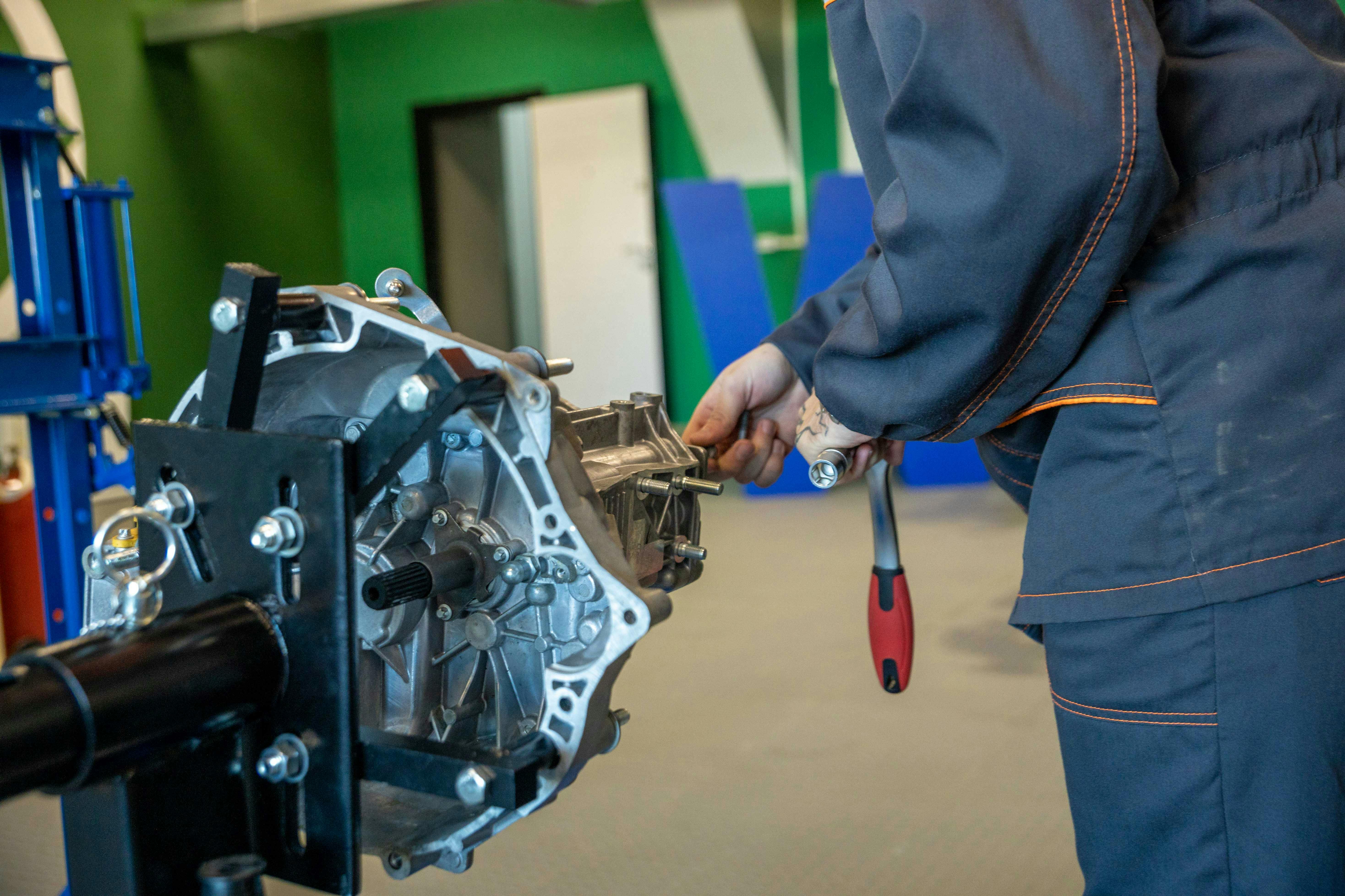 Professional garage technician repairing a vehicle transmission in Barking, London at BNS MOTORS