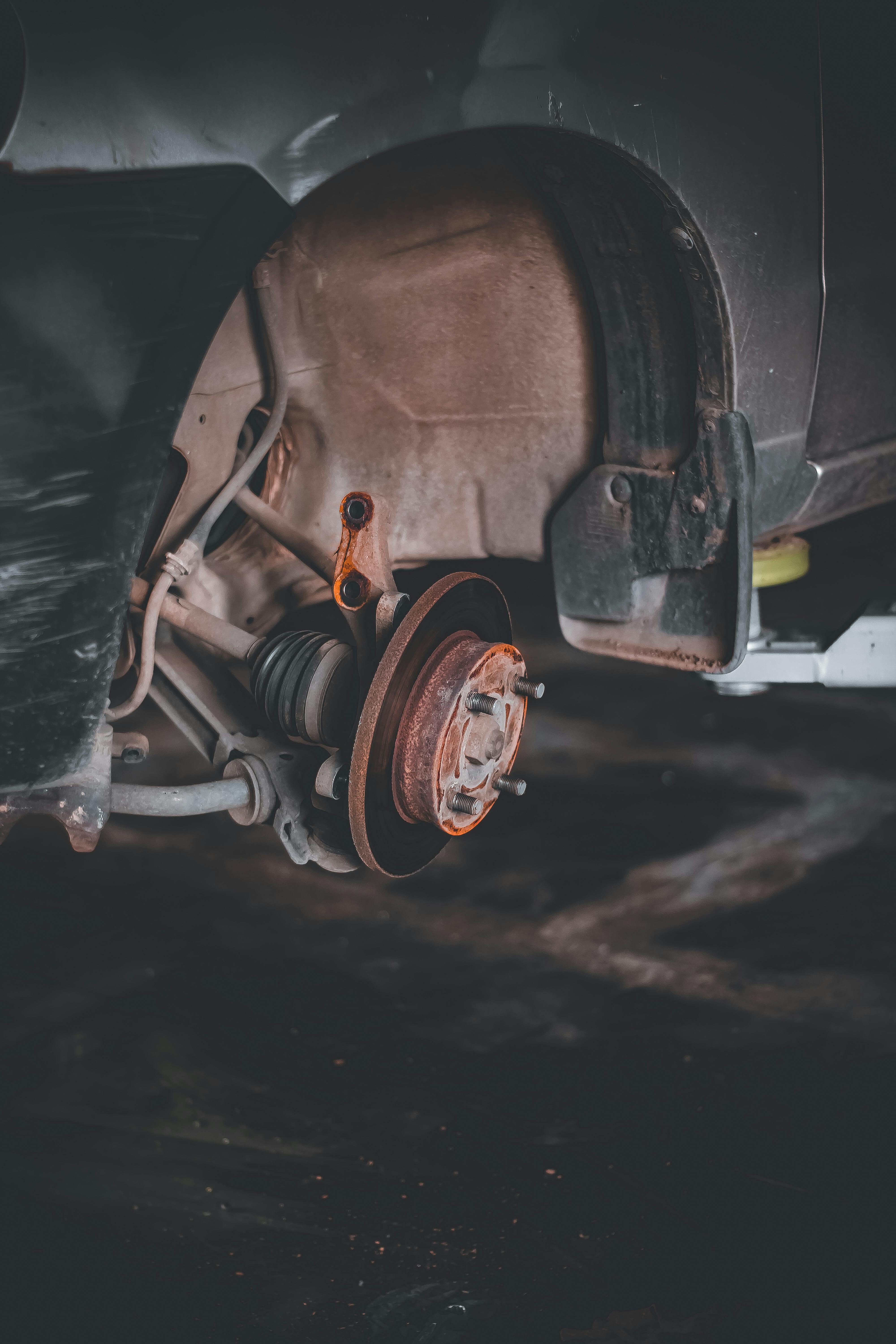 Car wheel and brake system during brake repair at BNS MOTORS, Barking, London.