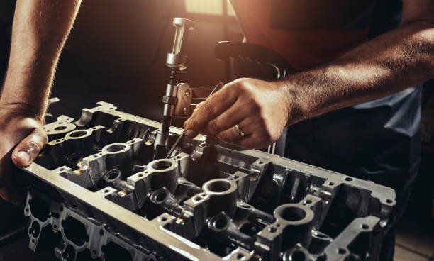 Auto Technician performing precision engine reconditioning and cylinder head repair at BNS MOTORS London