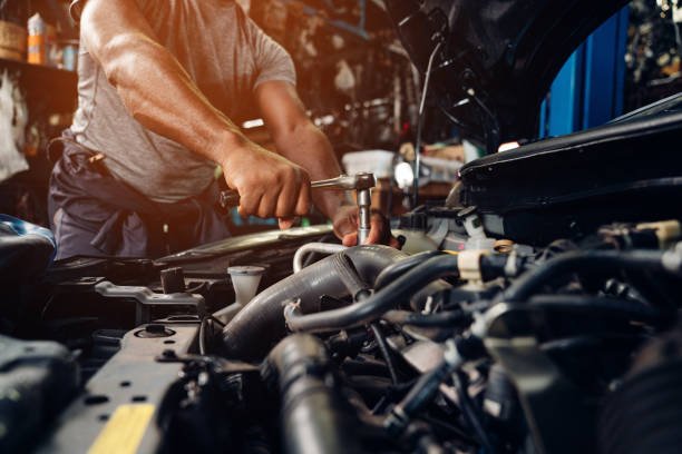 Mechanic performing professional engine repair and maintenance work at BNS Motors workshop in Upminster, East London.